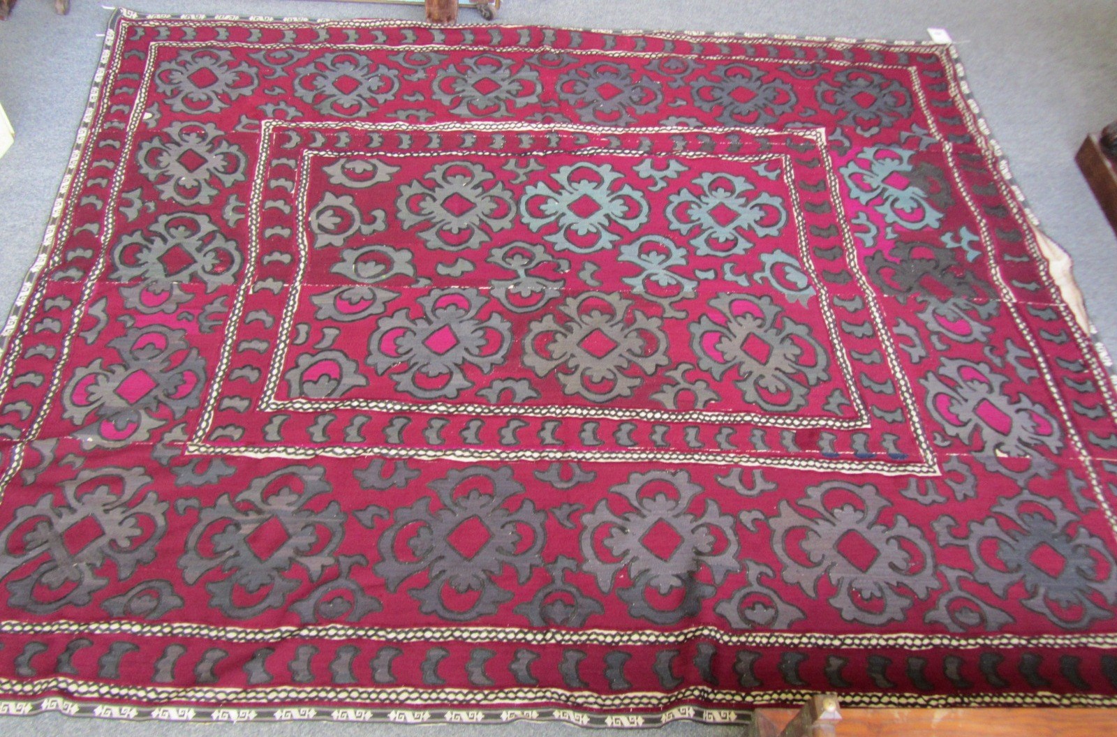 Appraisal: Two embroidered Susani coverlets the first a patterned burgundy ground