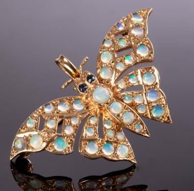 Appraisal: A ct gold butterfly pendant brooch with sapphire eyes and