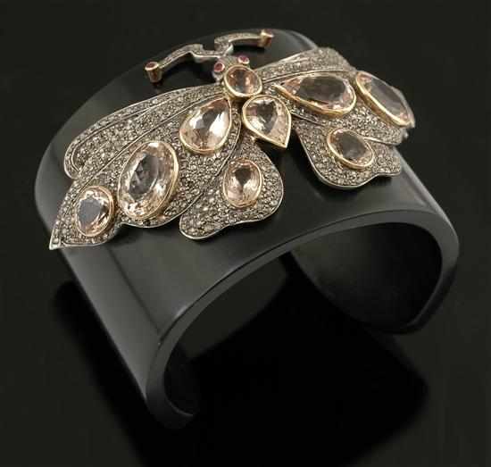 Appraisal: A gem set butterfly bangle The black resin cuff with