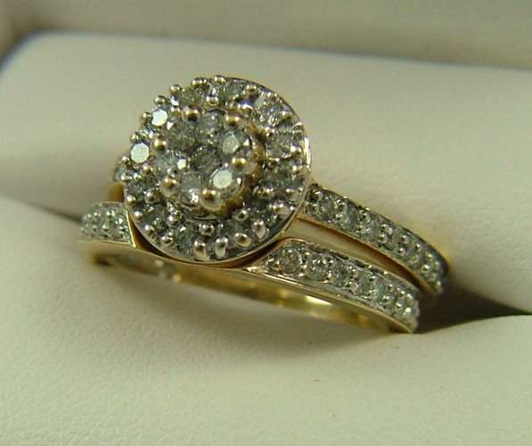 Appraisal: DIAMOND AND FOURTEEN KARAT GOLD RING WITH RING GUARD the