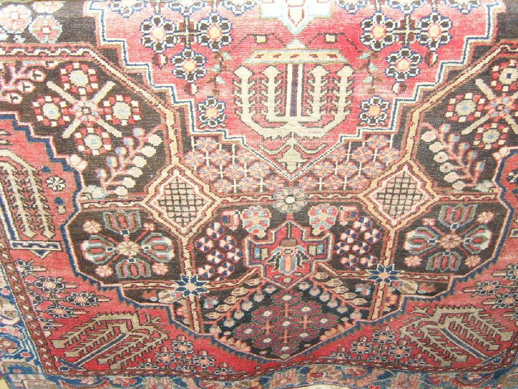 Appraisal: A red ground eastern wool rug with stylised floral and