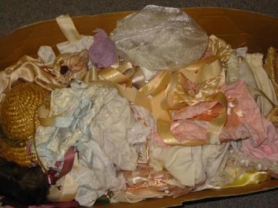 Appraisal: A box of assorted dolls clothes in cotton satin and