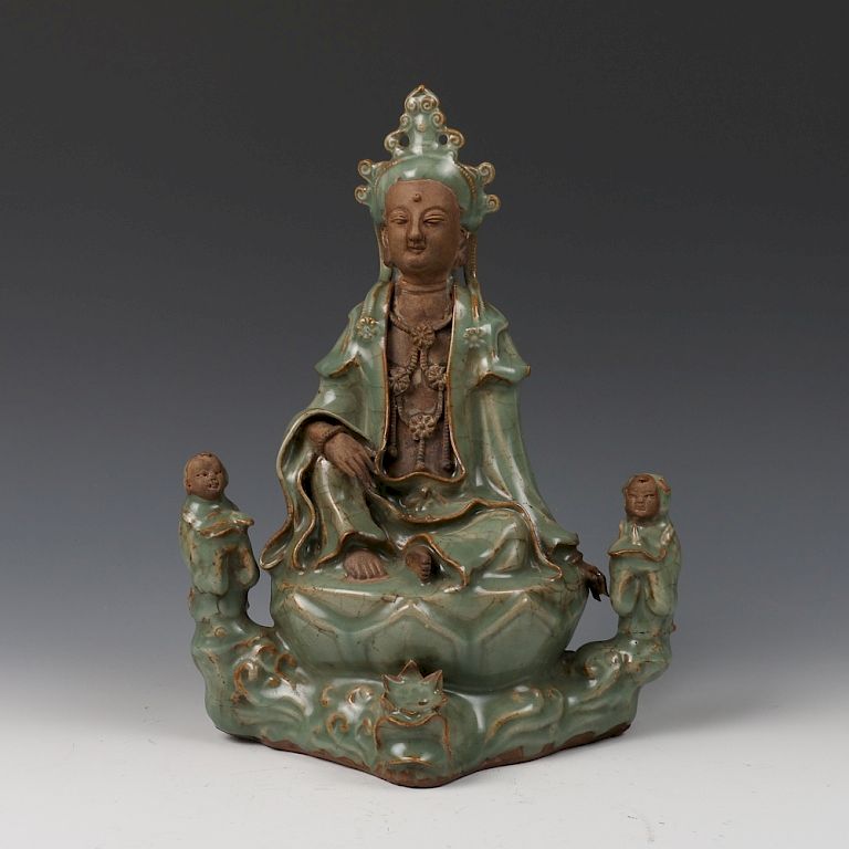 Appraisal: CHINESE CELADON GLAZE GUANYIN FIGURE A celadon glazed Guanyin figure