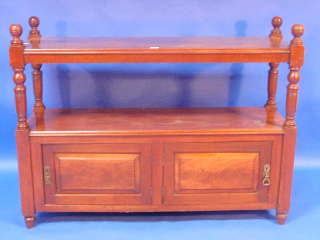 Appraisal: A Victorian walnut two-tier buffet stand fitted with two cupboards