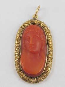 Appraisal: An antique gold mounted carved coral cameo pendant approx cm