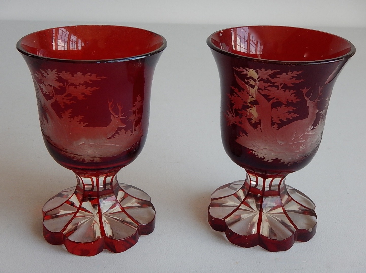 Appraisal: A pair of thC Austrian ruby flash and engraved goblets