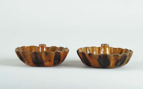 Appraisal: PAIR OF REDWARE GLAZED PUDDING MOLDS The outside with crimped