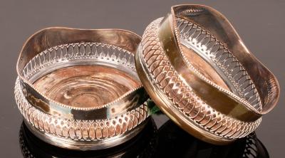 Appraisal: A pair of silver plated wine coasters with pierced sides