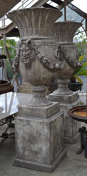 Appraisal: A PAIR OF COMPOSITE STONE VERSAILLES URNS each with flared