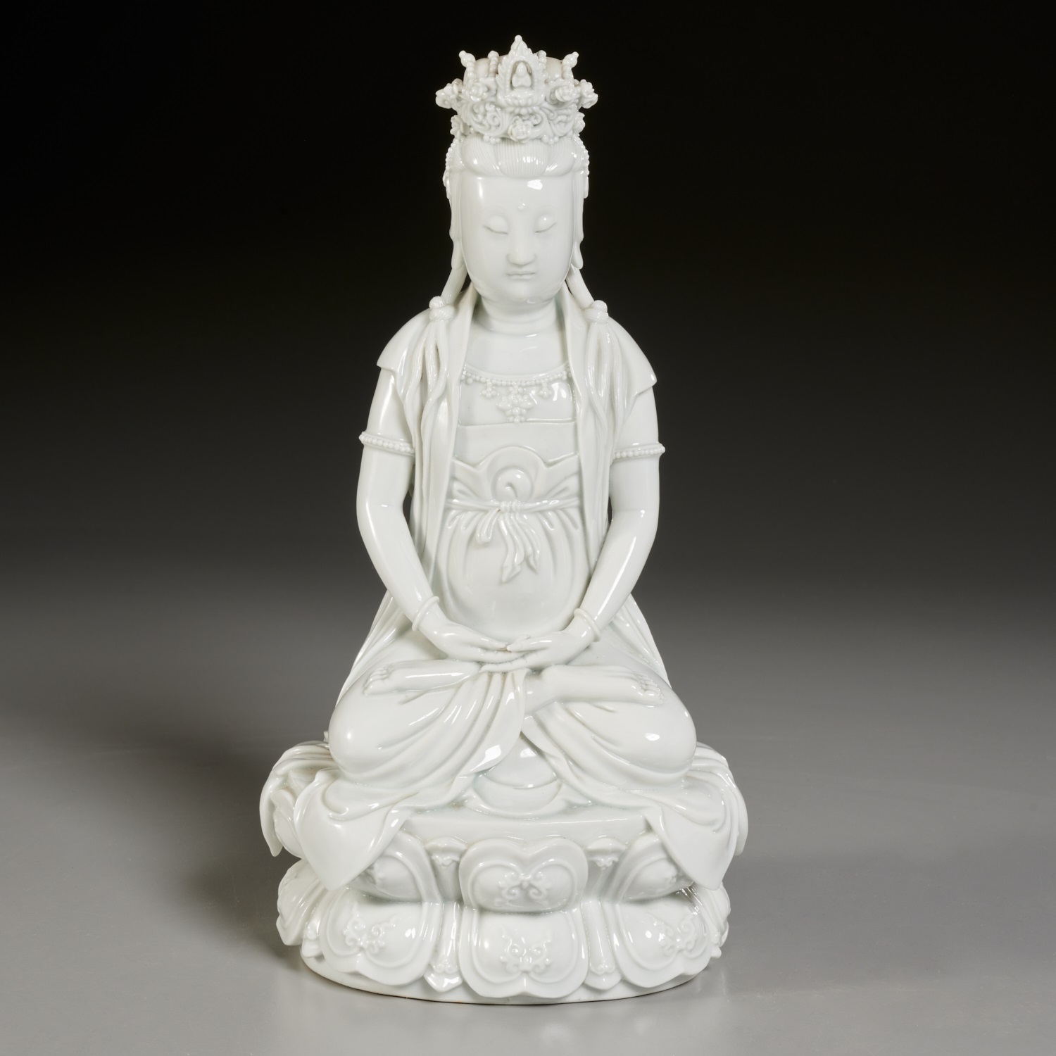 Appraisal: CHINESE MONOCHROME WHITE PORCELAIN GUANYIN Qing Dynasty th c seated