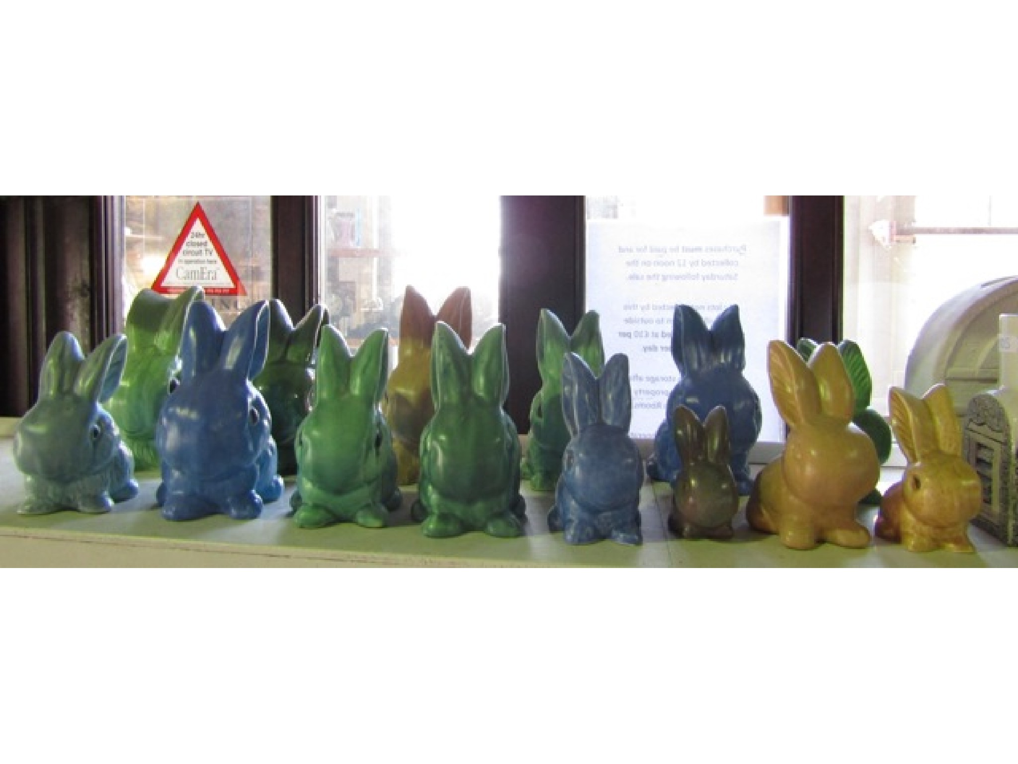 Appraisal: A collection of fourteen ceramic rabbits in various blue green