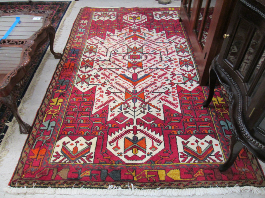 Appraisal: PERSIAN TRIBAL AREA RUG central geometric reserve and stylized floral