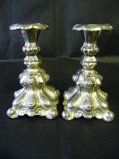 Appraisal: A pair of European Rococo style weighted silver plate candlesticks