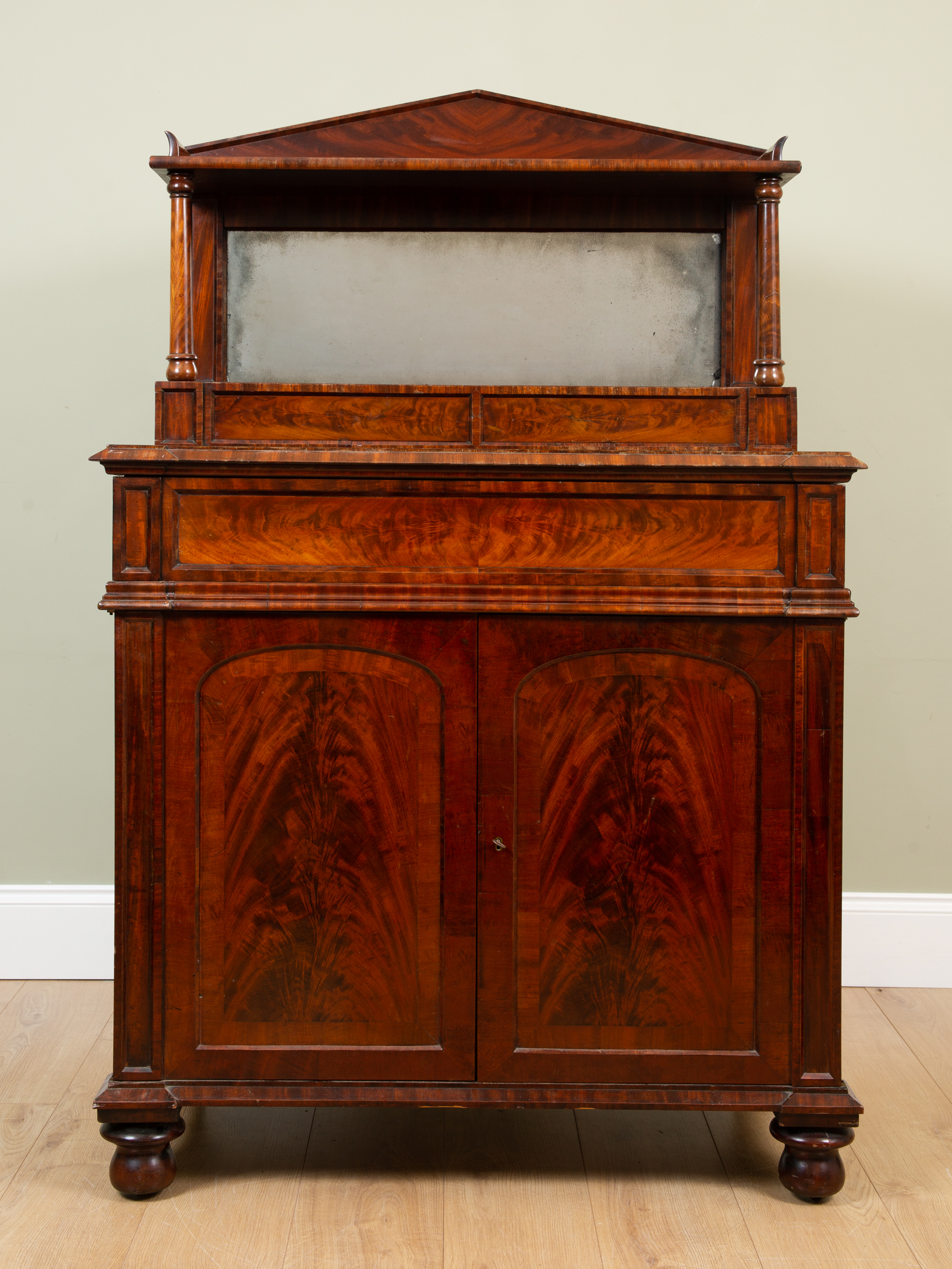 Appraisal: A William IIII mahogany library cabinet the raised mirrored back