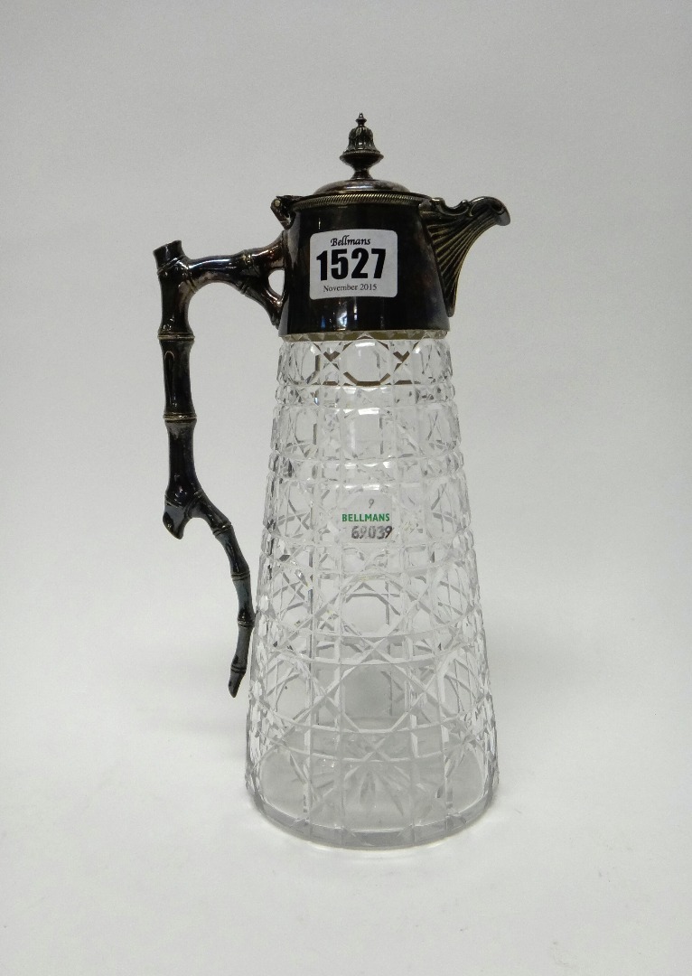 Appraisal: A silver plated metal mounted faceted glass claret jug the