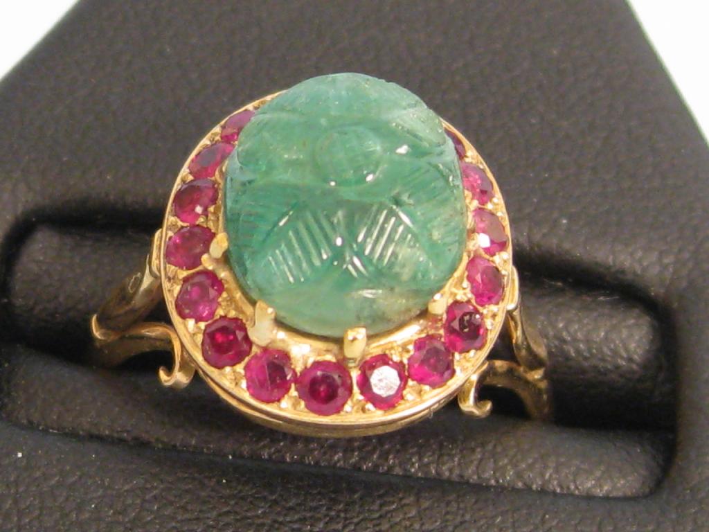 Appraisal: An Emerald and Ruby Ring the central carved oval emerald