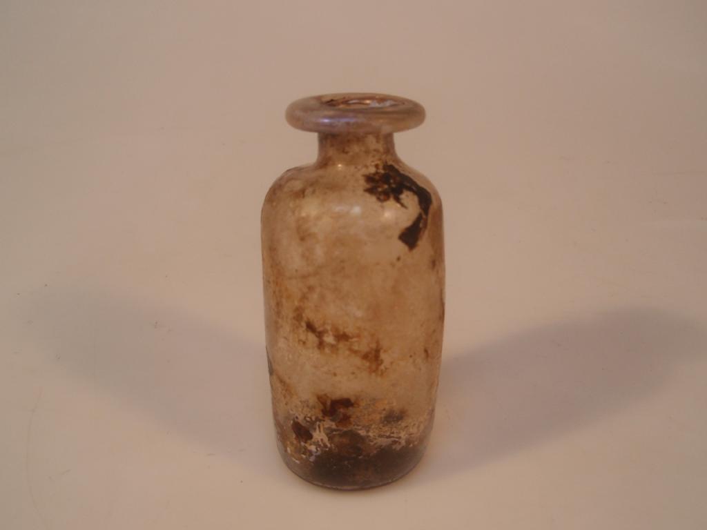 Appraisal: A small pale purple Roman cylindrical glass bottle the folded