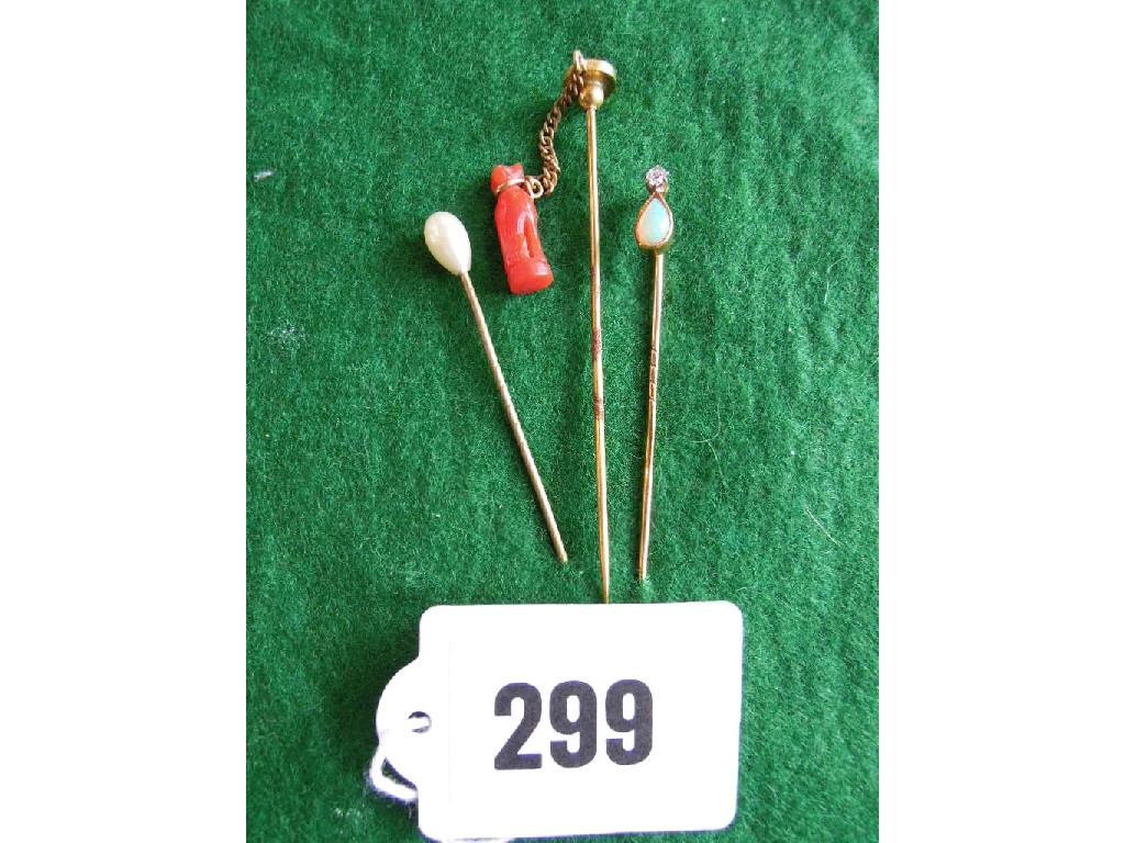 Appraisal: Three tie pins with one coral mount in the form