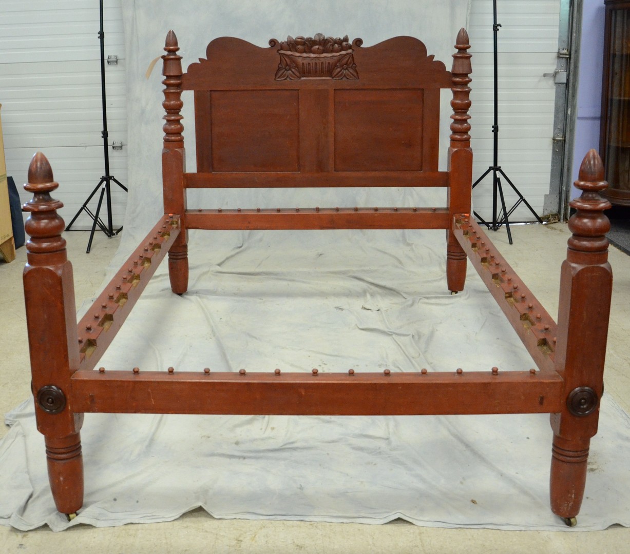 Appraisal: Turned and carved acorn post red painted rope bed with