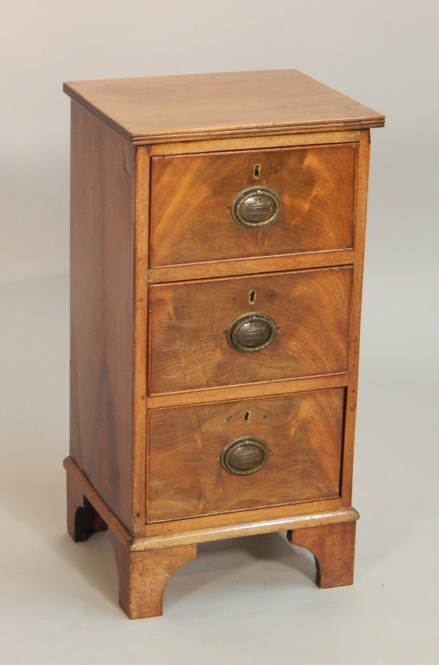 Appraisal: A narrow mahogany chest of three drawers the top with