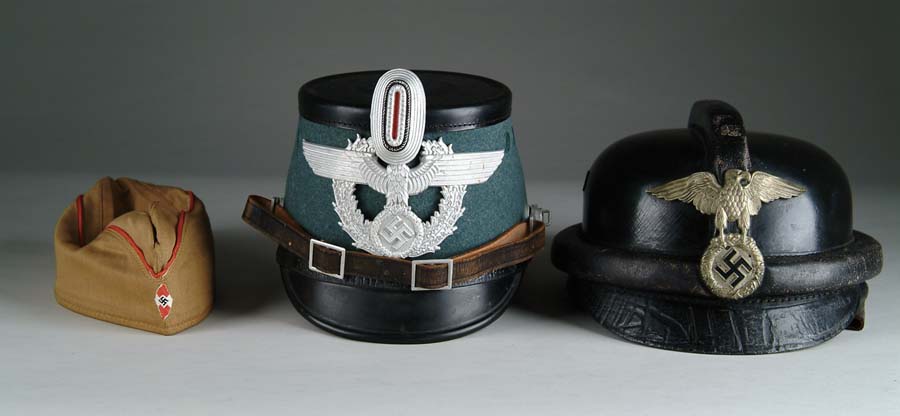 Appraisal: LOT OF HELMETS Hard form police helmet with large eagle