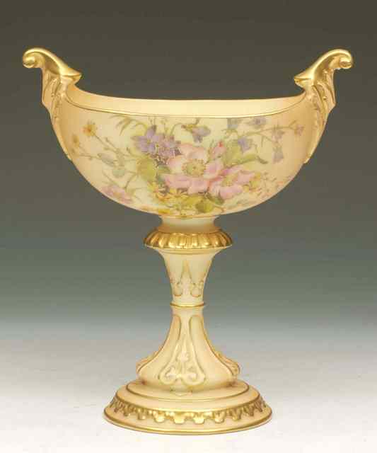 Appraisal: A ROYAL WORCESTER PORCELAIN OVAL CHALICE with gilded scroll handles