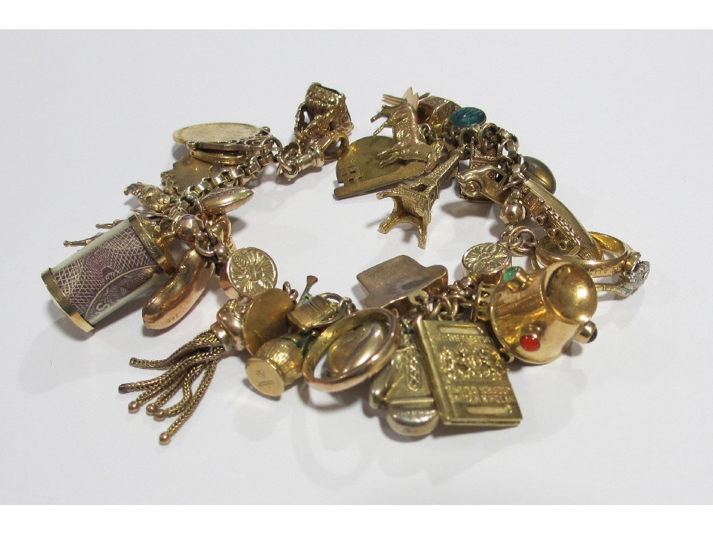 Appraisal: A nine carat gold charm bracelet with various gold charms