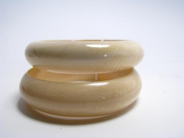 Appraisal: Two solid ivory bangle bracelets