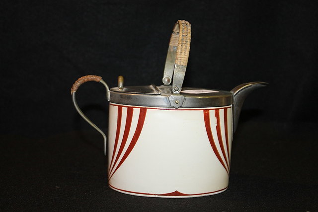 Appraisal: A SECESSIONIST TEAPOT with WMF mounts and partial wicker handles