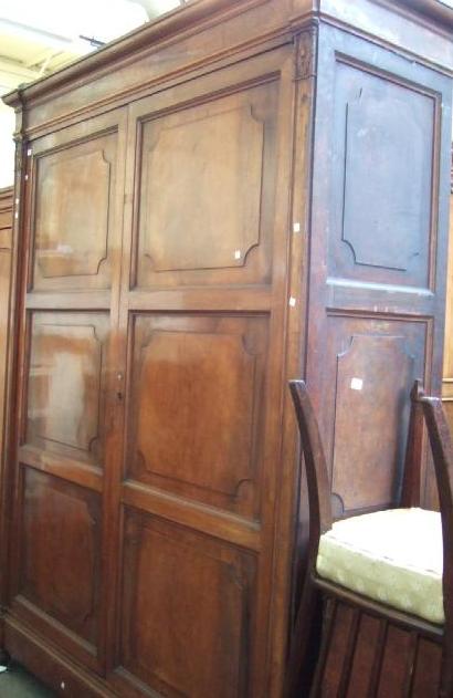 Appraisal: A th century North Italian walnut wardrobe the fielded panel