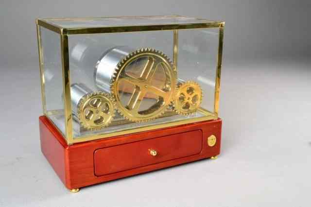 Appraisal: RAPPORT WATCH WINDER IN GLASS CASEDepicting three large gears in