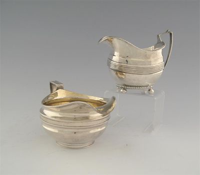 Appraisal: A George III squat circular cream jug with a bifurcated