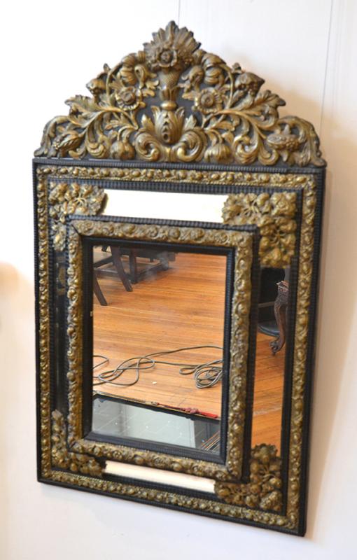 Appraisal: AN EBONISED AND EMBOSSED BRASS MOUNTED CUSHION FRONT WALL MIRROR