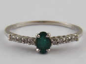 Appraisal: A white metal tests carat gold emerald and diamond ring