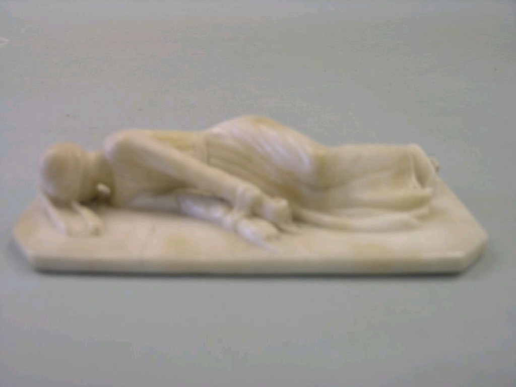 Appraisal: A carved alabaster sculpture study of a lady lying on