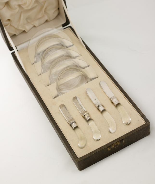 Appraisal: CASED SET OF FOUR GLASS BUTTER DISHES AND KNIVES THOMAS