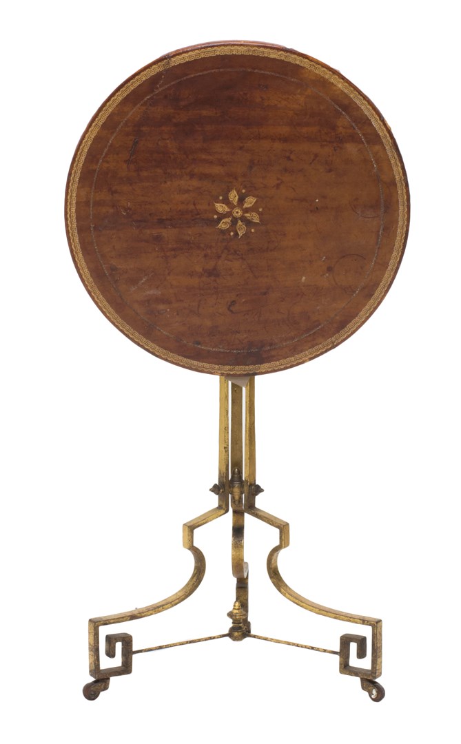 Appraisal: A French occasional table the tooled leather circular top on