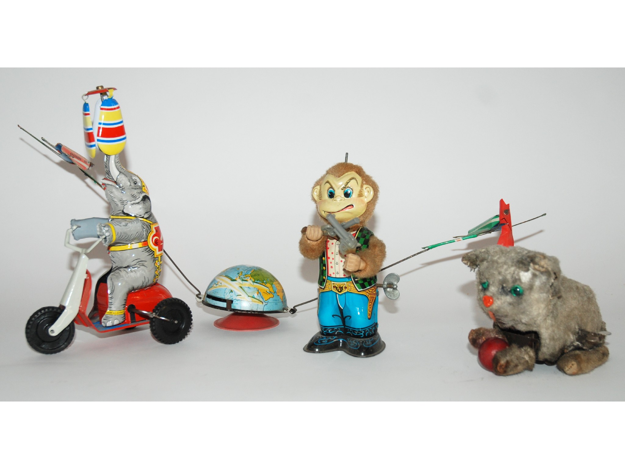 Appraisal: Three various tinplate clockwork toyscomprising elephant on tricycle stamped Made