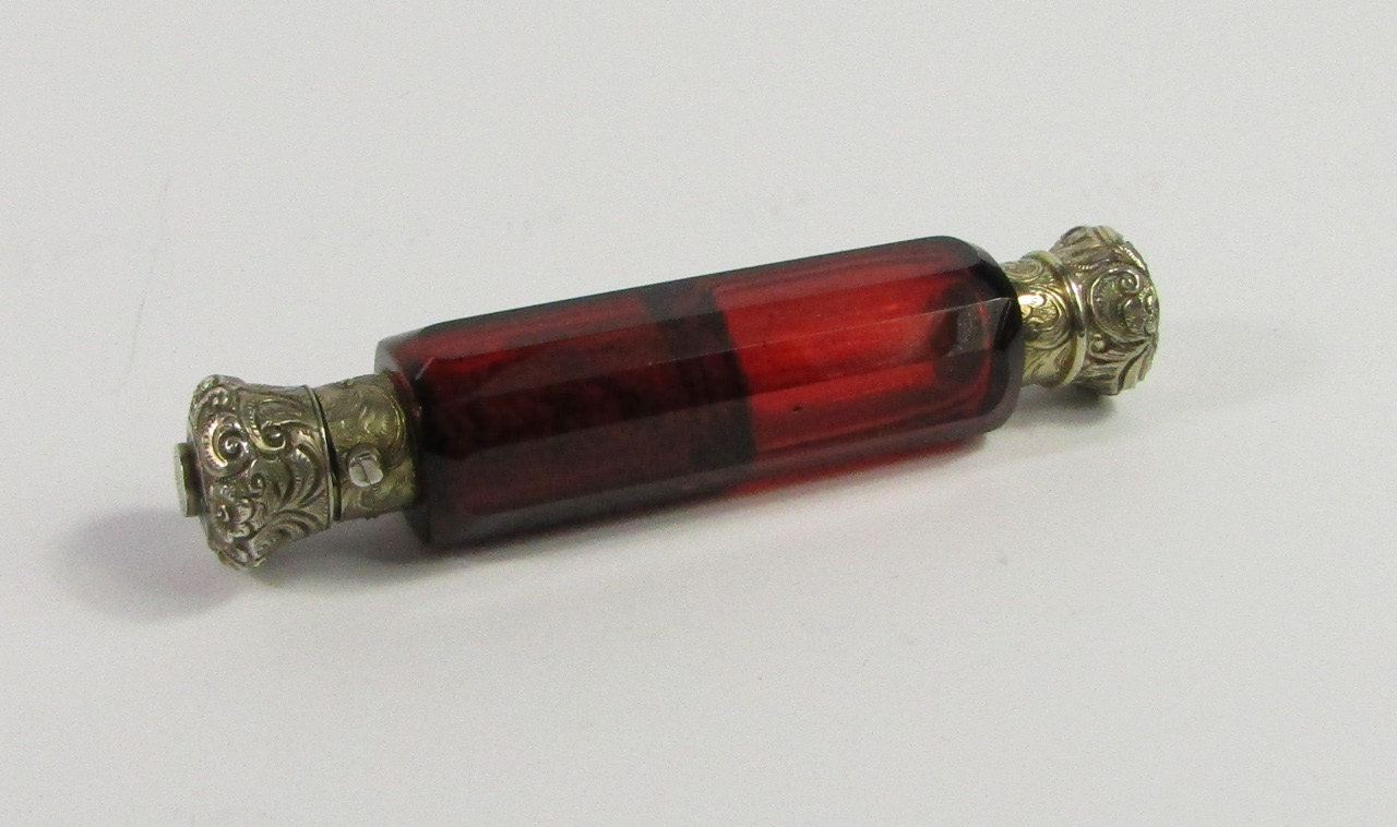 Appraisal: A Victorian cranberry faceted glass double ended scent and smelling