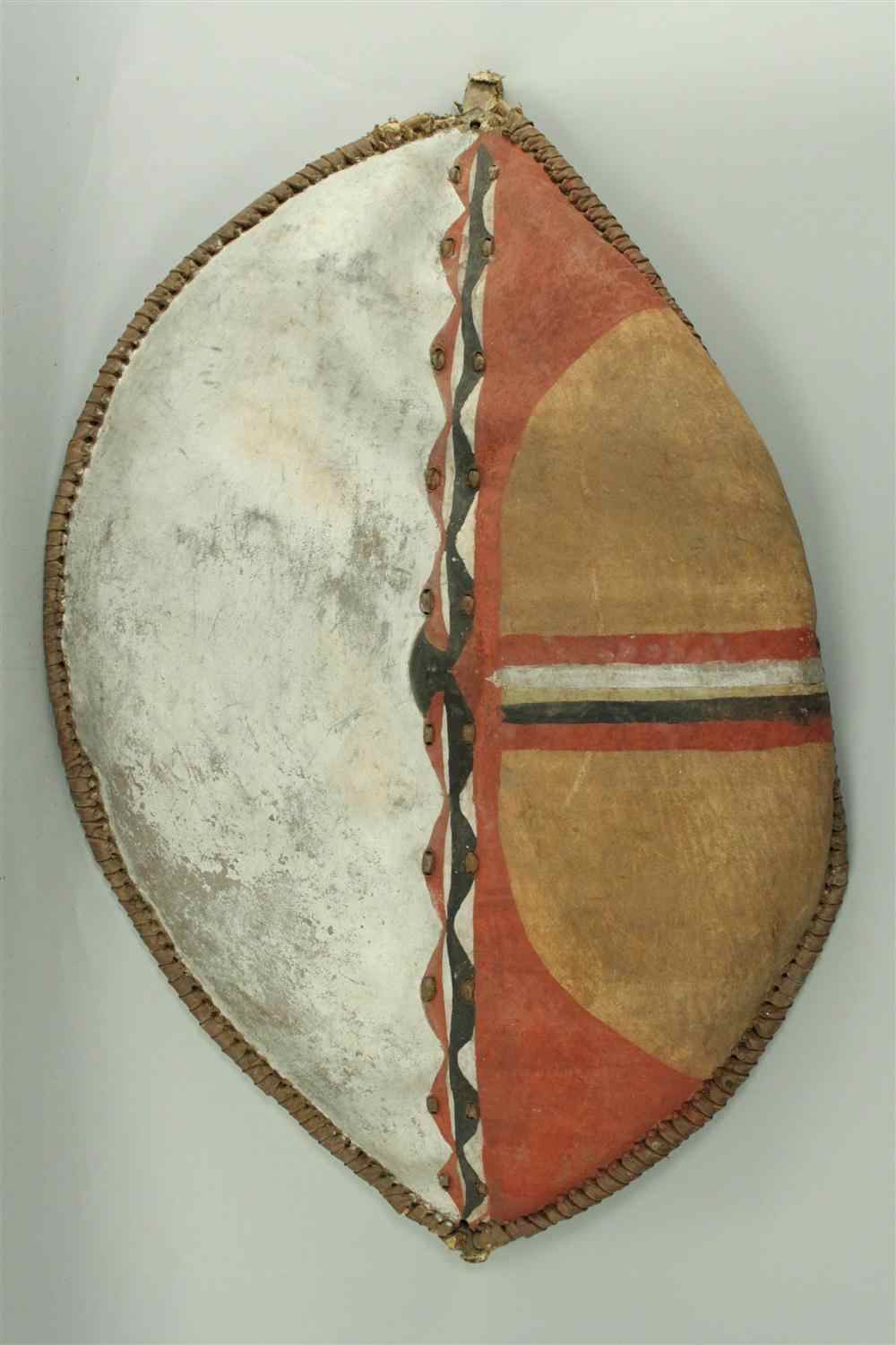 Appraisal: MAASAI SHIELD EARLY TH CENTURY left half painted white the