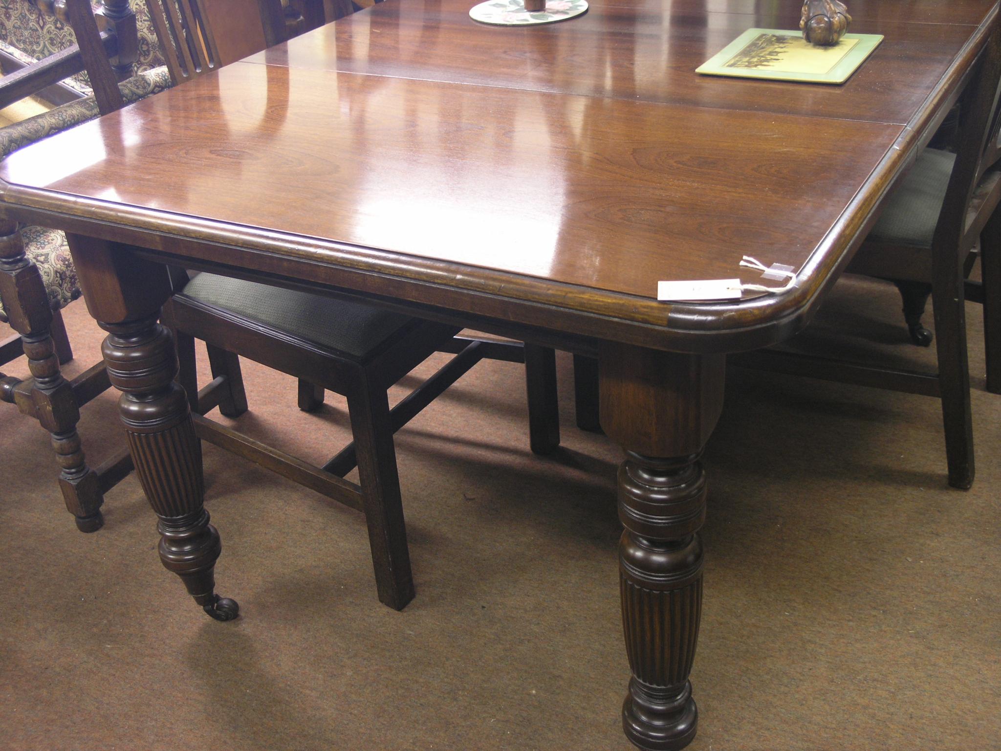 Appraisal: A Victorian walnut draw-leaf dining table with winding crank and