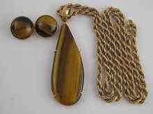 Appraisal: A yellow metal tests carat gold tiger's eye pendant approx