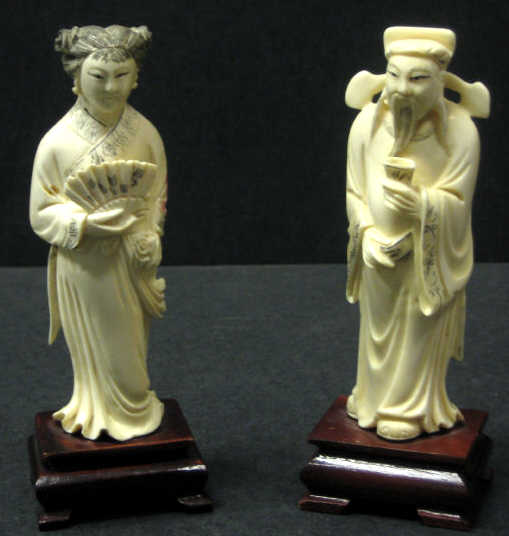 Appraisal: PAIR OF CHINESE CARVED IVORY FIGURES Male with cup and