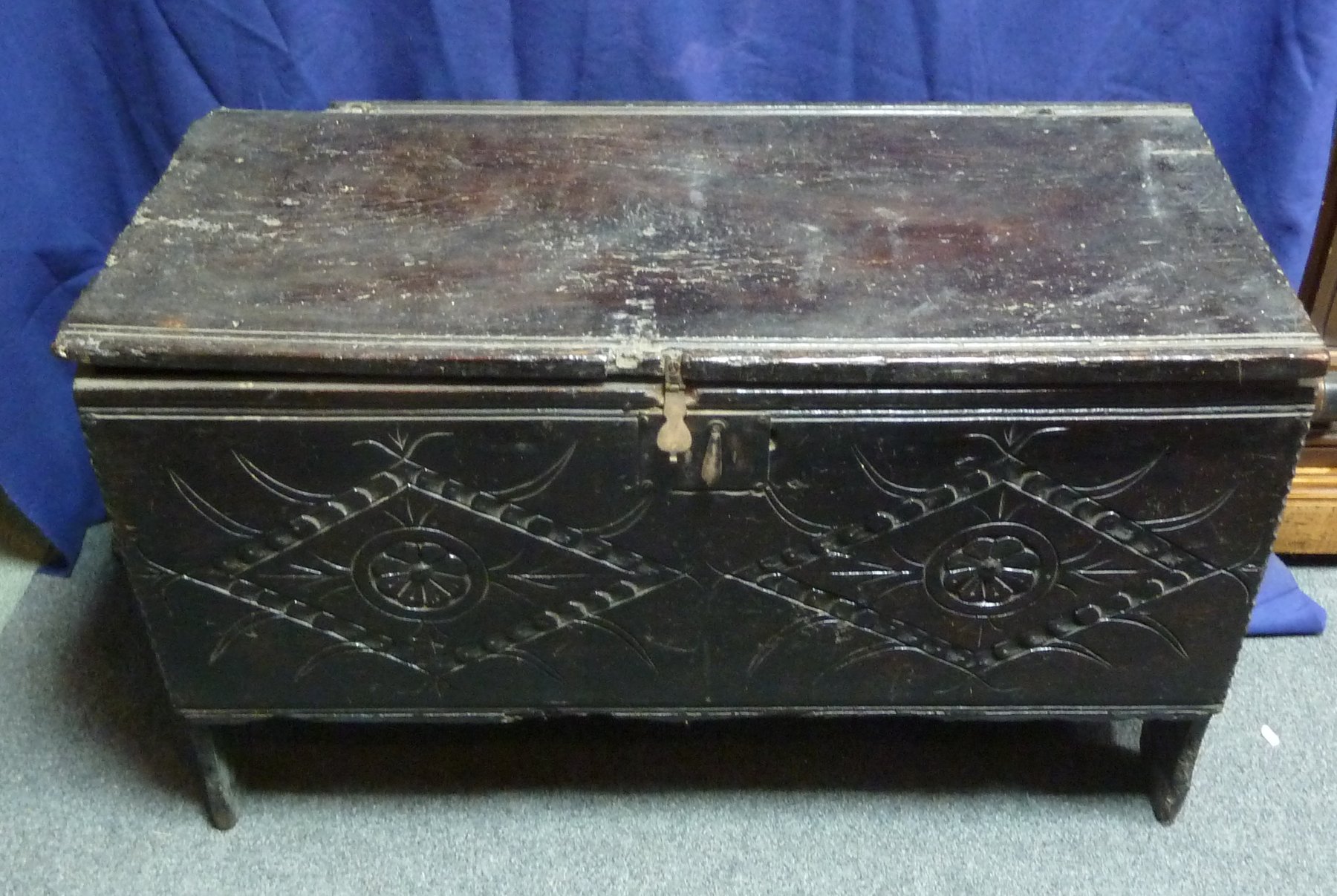 Appraisal: An oak chest with plain hinged cover carved diapers foliage