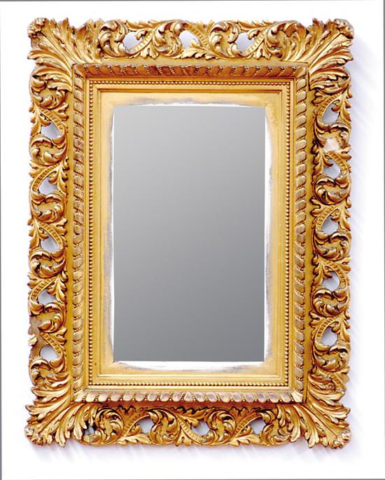 Appraisal: Rococo style giltwood looking glass scrolling foliate and pierce-carved frame