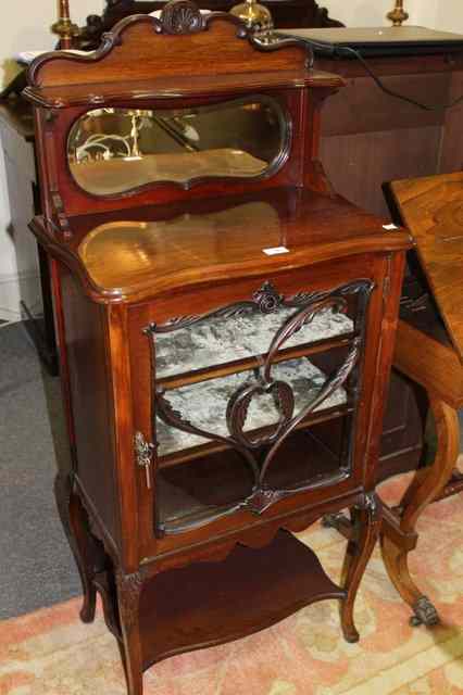 Appraisal: AN EDWARDIAN WALNUT MUSIC CABINET with raised mirror back lower