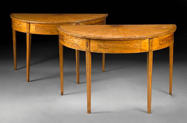 Appraisal: A pair of Continental Neoclassical style marquetry and fruitwood demilune