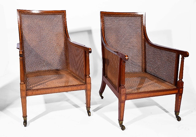 Appraisal: Pair of mahogany and inlaid Bergere armchairseach with cane back