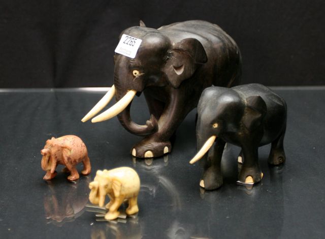 Appraisal: Two carved hardstone miniature elephants together with an ebony and