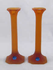 Appraisal: A pair of Russian frosted finish coloured glass candlesticks in